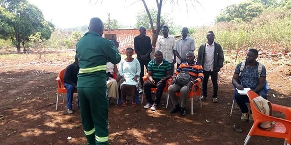 EWES surveyor holding a discussion with residents of a mining area