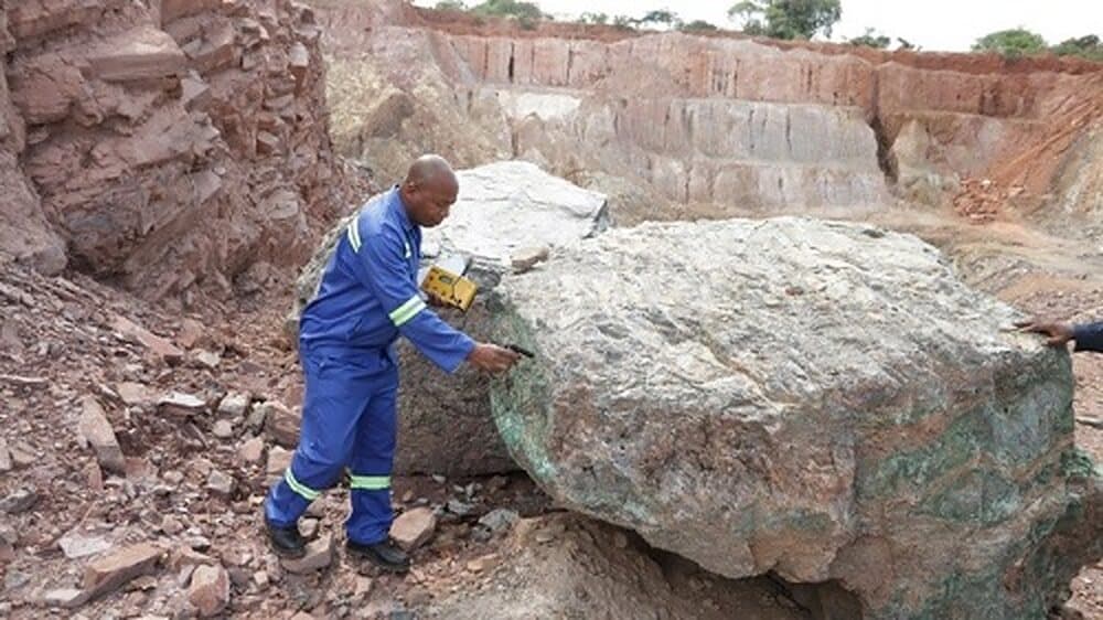 EWES expert examining a mineralised outcrop at a mining site